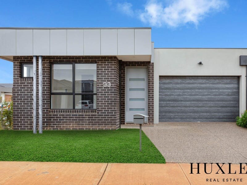Brick and white facade with front lawn at 33 Maya Avenue